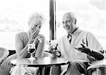 Mature man and woman talking in a cafe, B&W