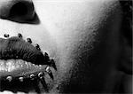 Woman's lips with jewel adornments, partial view, close-up, B&W