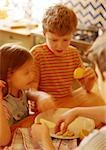 Enfants dans la cuisine, mettre les tranches de pomme sur plaque, floue