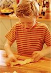 Child handling pastry dough, blurred motion