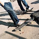 Two people with skateboards, low section