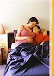 Pregnant woman and child in bed