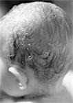 Baby's head with shampoo in hair, rear view, close-up, b&w
