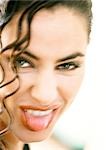 Woman sticking out tongue, close-up, portrait, blurred