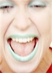 Woman with green lipstick laughing, close-up