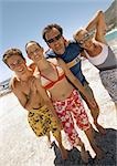 Family standing on the beach.