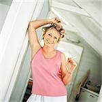 Mature woman with rollers in hair holding cigarette