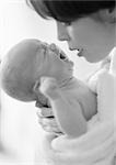 Mother holding crying infant, b&w