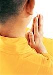 Buddhist monk meditating, rear view, close-up