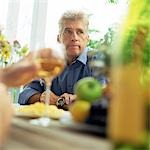 Mature man sitting at table