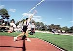 Male athlete throwing javelin, blurred motion