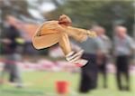 Female long jumper in mid-air, blurred motion