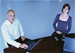 Businessman and woman sitting at desk