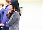 Businesswoman holding book, side view