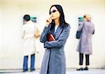 Businesswoman in front of cash machines