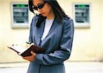 Businesswoman taking notes in the street