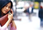 Businesswoman using cell phone, close-up