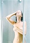 Woman taking shower, covering breast
