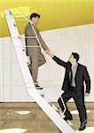 Two men standing on ladder, shaking hands