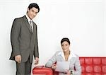 Businesswoman and businessman in office lobby