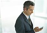Businessman dialing cell phone