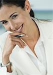 Businesswoman holding pen and smiling
