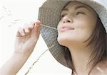 Young woman with blade of grass in mouth