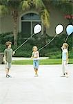 Suburban children holding balloons