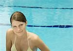 Woman smiling, poolside