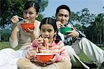 Family eating meal in the park