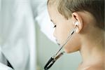 Boy listening to stethoscope