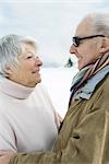 Senior couple smiling at each other, side view, portrait