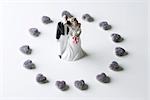 Miniature bride and groom surrounded by candy hearts