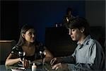 Couple having serious conversation over dinner with wine at restaurant