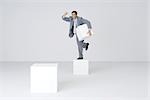 Businessman holding pedestal block, shaking fist