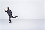 Businessman running with document