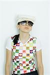 Teen girl wearing cap and sunglasses, portrait