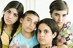 Four young female friends looking glum, portrait