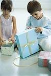 Boy and girl opening presents