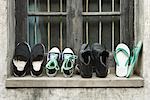 Shoes lined up on windowsill