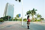 Young woman waiting to cross street