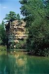 Verdant waterscape with crag