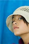 Teenage girl wearing hat, looking at camera, close-up