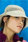 Teenage girl wearing hat, looking at camera, portrait