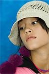 Teenage girl wearing hat, looking away, portrait