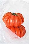 Heirloom tomatoes in plastic bag, close-up