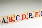 Wooden alphabet blocks in a row, close-up