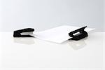 Stapler and hole puncher with single sheet of paper