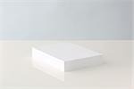 Stack of blank paper resting on table