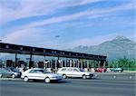 Cars leaving tollbooths